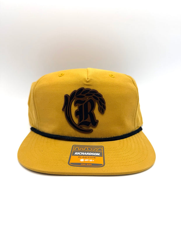 Gold hat with dark custom monogram patch