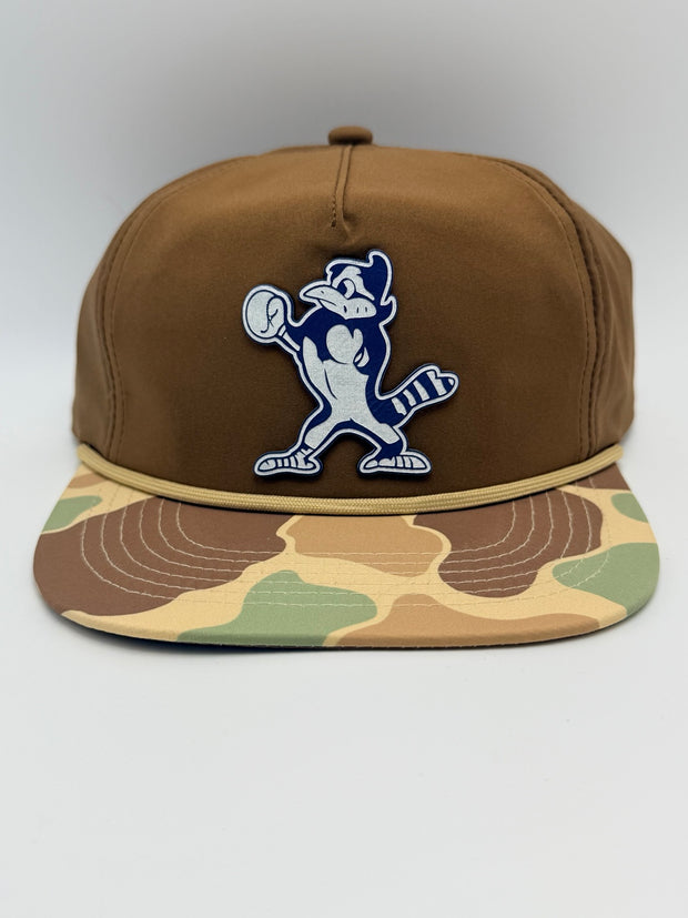 Brown hat with camouflage brim and baseball raccoon patch